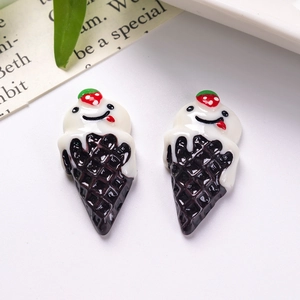 Macro shot of cute resin ice cream cone charms with smiling faces for DIY crafts