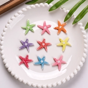 Detailed macro view of colorful acrylic starfish beads with textured surface and holes