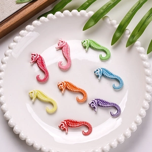 Close-up of colorful acrylic seahorse beads with textured stripes for DIY jewelry making