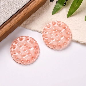 Macro shot of two pink resin cookies with wavy edges and textured details for DIY crafts