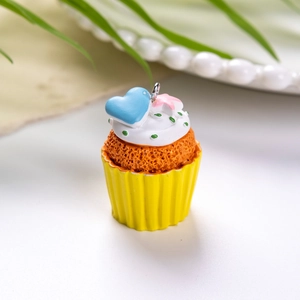 Λήψη macro από κρεμαστό cupcake με πολύχρωμα διακοσμητικά και ασημί μεταλλικό κρίκο