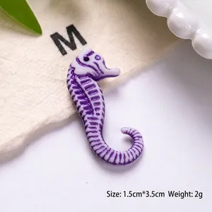 Detail of purple and white seahorse acrylic charm with 1.5cm by 3.5cm measurement