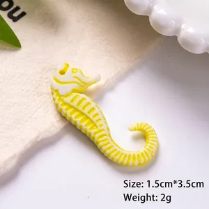Macro shot of 3.5cm yellow seahorse charm with size measurements for DIY jewelry