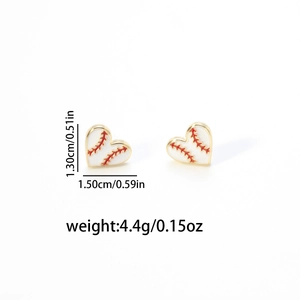 Close-up of heart-shaped baseball stud earrings featuring red stitching and enamel finish