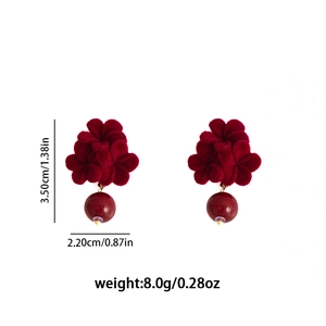 Detail view of red velvet rose earrings with dimensions 3.5cm by 2.2cm and pearl drop