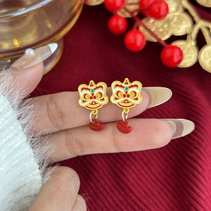 Detalle de pendiente de danza del león chino con esmalte rojo y acabado dorado