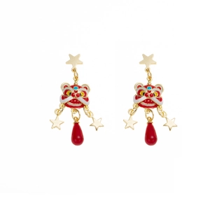 Detalle de pendientes de león chino con gotas rojas y estrellas doradas de estilo