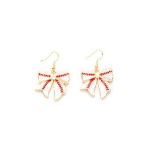 Detail of creative gold bow earrings featuring red baseball stitching and white textures