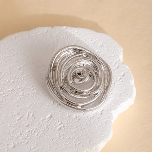 Artistic silver geometric spiral brooch with hollow irregular layers and a polished finish