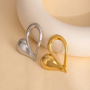 Minimalist hollow heart shaped brooch in polished gold and silver stainless steel