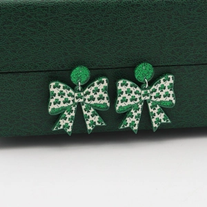 St. Patrick's Day clover print bow acrylic earrings with green glitter details