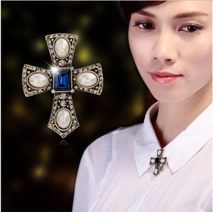 Vintage gold cross brooch with blue gemstone, white pearls and sparkling rhinestones