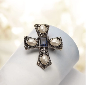 Vintage baroque cross brooch with white pearls, blue crystal, and sparkling rhinestones