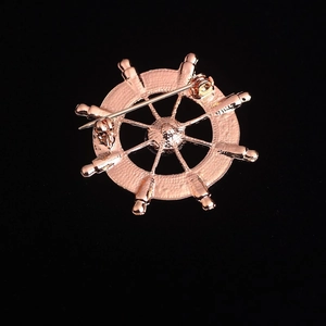 Close-up of the rose gold steering wheel brooch back showing the pin safety clasp detail