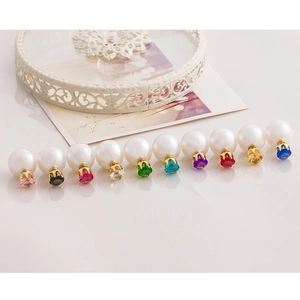 Macro display of ten pairs of double-sided pearl earrings with multicolored gemstones