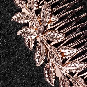 Exquisite rose gold leaf hair comb accessory with detailed metal textures on black background