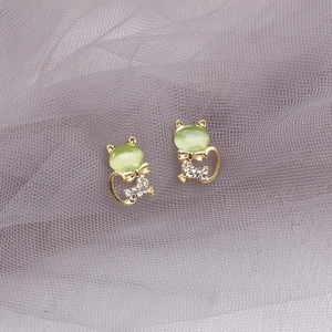Golden cat stud earrings with opal stone and sparkling rhinestones on purple lace