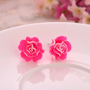 Elegant bright pink multi-layer rose stud earrings with white petal edges in ceramic dish