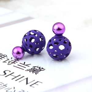 Macro view of purple double-sided ball earrings featuring matte hollow and mirror finishes