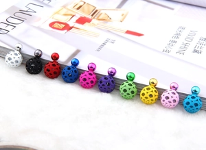 Macro shot of 11 colorful hollow spherical earrings with intricate metal floral patterns