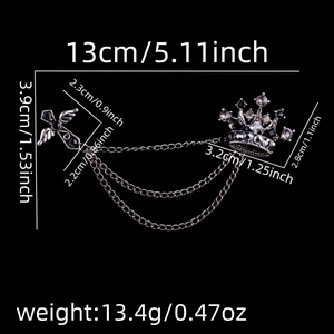 Detailed specs of vintage crown and winged cross brooch with silver tassels and chains