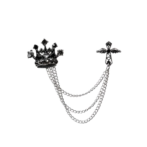 Men's vintage crown and winged cross brooch with silver chains on white background