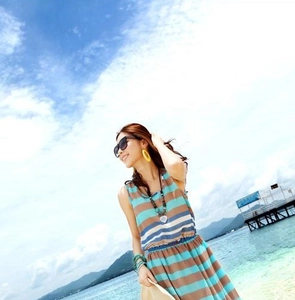 Detail view of summer striped sleeveless dress with waist belt and beach accessories