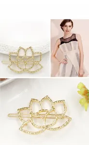 Detailed macro view of golden lotus flower hair clip with elegant cutout metal design