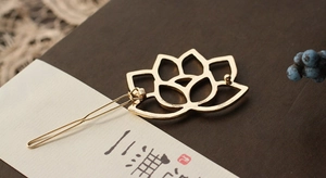 Detail of golden hollow lotus hair clip featuring S925 stamp and elegant metal petals
