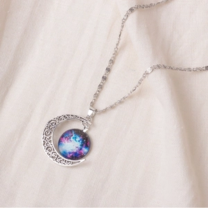 Starry sky moon necklace featuring a crescent pendant with nebula stone on linen texture