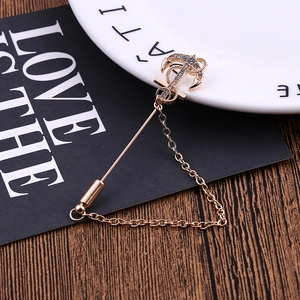 Vintage golden anchor brooch with sparkling white rhinestones and a decorative chain pin