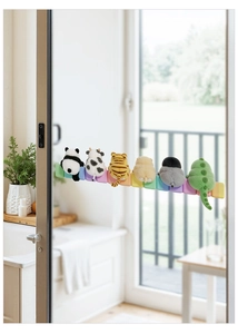 Close-up of plush cartoon animals on a colorful base attached to a glass door