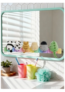Detail of colorful plush cartoon animal wall stickers arranged on a bathroom mirror