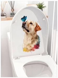 Detailed close-up of a golden retriever dog and blue butterfly sticker on a white toilet lid