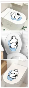 Detailed views of a cartoon dog sitting on a toilet sticker applied to a bathroom lid