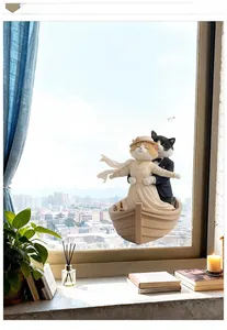 Detail of titanic cat figurines on boat with My Heart Will Go On text display
