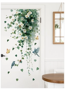 Detail of floral vine wall stickers with white daisies and blue birds on a white door