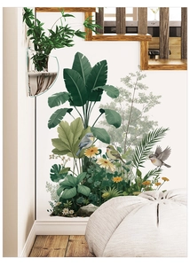 Detail of tropical palm leaf wall decals with colorful birds and daisies in a cozy living room
