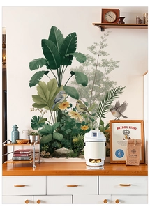 Detail view of tropical palm leaf wall decals with birds in a cozy home setting