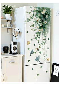 Detail of white daisy and green vine wall stickers applied to a white refrigerator