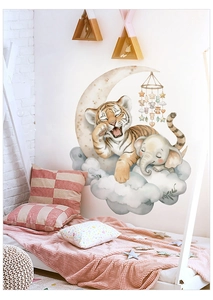 Close-up of cute cartoon tiger on moon and elephant wall stickers in a kids bedroom