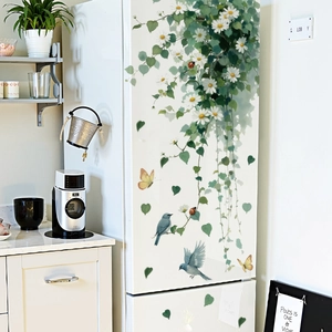 Floral vine wall sticker with white daisies, green leaves and blue birds on fridge