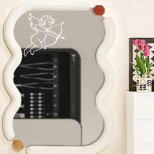 Modern wavy mirror with cupid decal and decorative colorful spheres for home decor