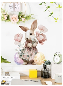 Detail of Easter bunny wall sticker with floral dress and decorative eggs on white wall