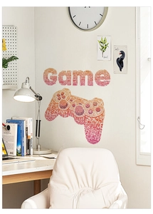 Detail of creative orange gradient gamepad wall decal in a modern gaming room setup