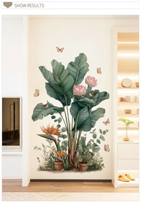 Close-up of tropical wall decal featuring large green leaves, pink lotus and birds