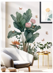 Detail of tropical plant wall stickers with banana leaves and birds on white wall
