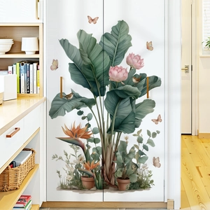 Tropical wall decals with green banana leaves and pink flowers on white cabinet