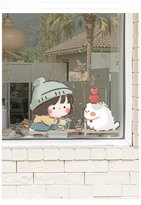 Detail of cute girl and cat UV glass sticker applied on a bright window for home decor