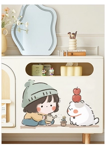 Detail of cute girl and cat UV printed stickers on a cream storage cabinet surface